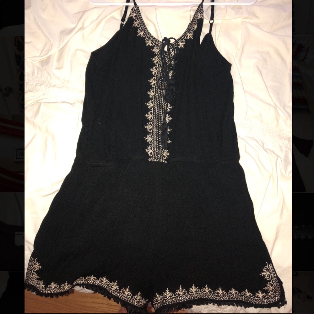 Black romper with gold accents